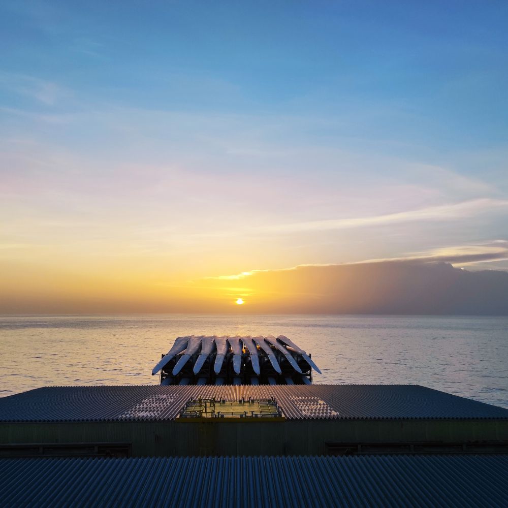 Picture of the deck of a G2 Ocean owned open hatch shipping vessel sailing in the sunset